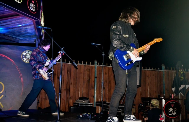 A guitarist performing on the Red Oak stage.